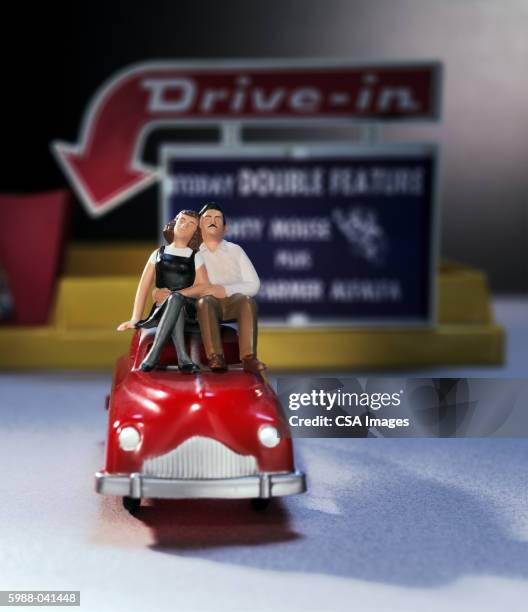 toy couple on car at drive-in - drive in cinema stock pictures, royalty-free photos & images