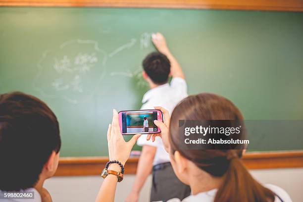 female student writing happy words, chinese and english, hong kong - bilingual stock pictures, royalty-free photos & images