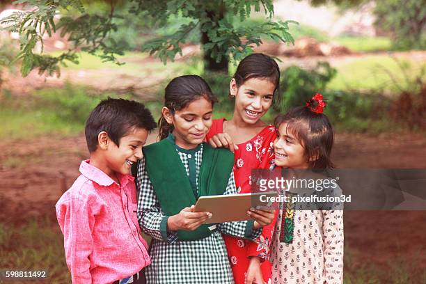 group of children enjoying digital tablet - rural scene stock pictures, royalty-free photos & images