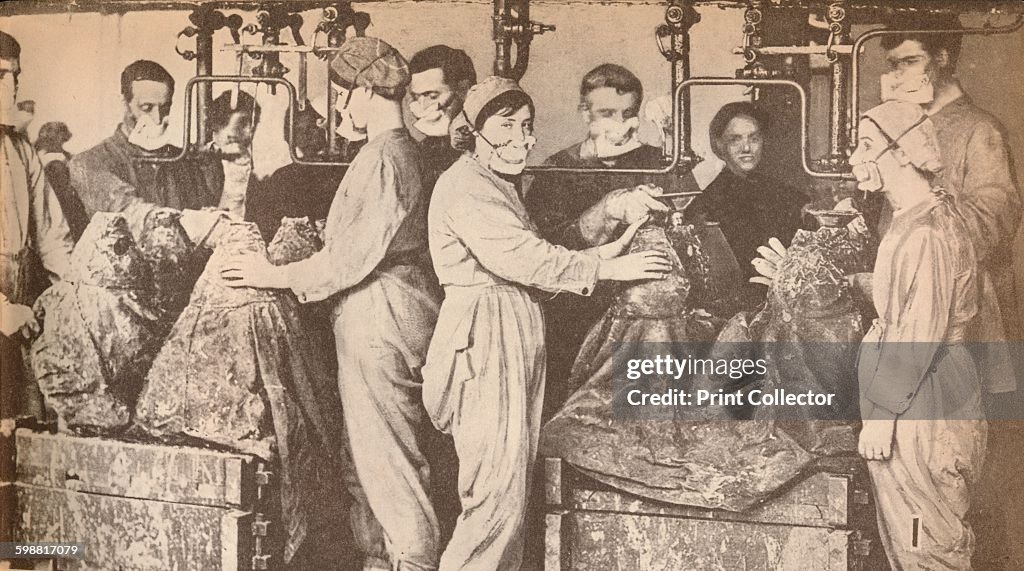 Munition Workers Wearing Respirators While Filling Sells with Trinitrotoluene (T