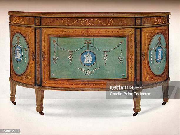 Commode of Lunette Form, circa 1775. Commode of Lunette Form, Inlaid with East India Satinwood and Borders of Harewood and Tulipwood, Ornamented with...