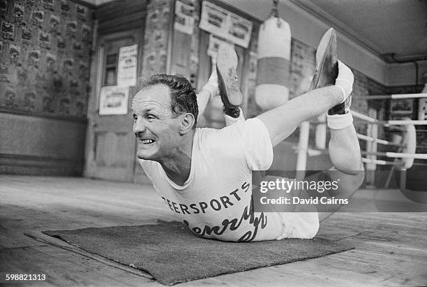 English heavyweight boxer Henry Cooper training at the Thomas a Becket gymnasium on the Old Kent Road, for his upcoming fight with Billy Walker,...