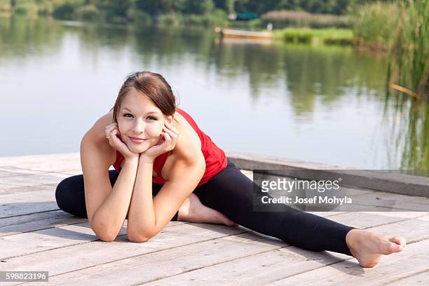 yong woman performs stretching relaxation - josef mohyla stock pictures, royalty-free photos & images