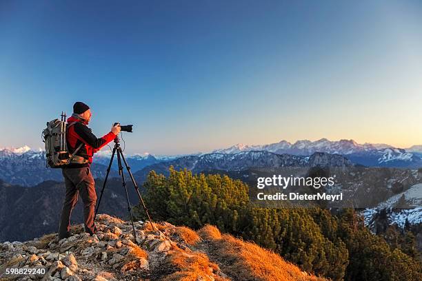 nature photographer with tripod an backpack  in the alps - landscape photographer stock pictures, royalty-free photos & images