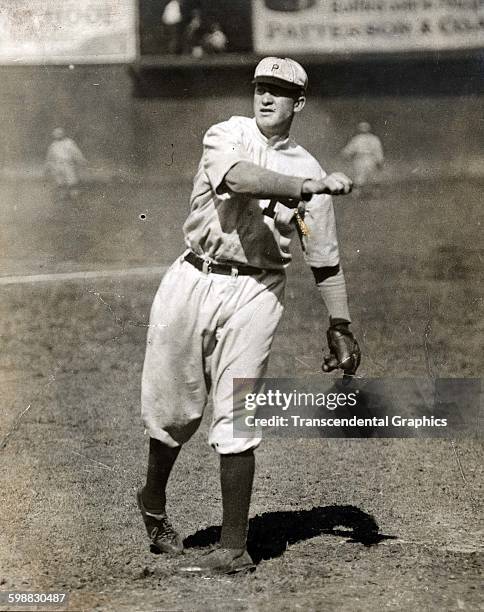 Baseball player Grover Cleveland Alexander throws a ball during a pre-game warmup at the Baker Bowl, Philadelphia, Pennsylvania, 1915.