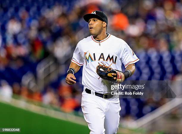 Robert Andino of the Miami Marlins runs off the field during the game against the San Diego Padres at Marlins Park on August 26, 2016 in Miami,...