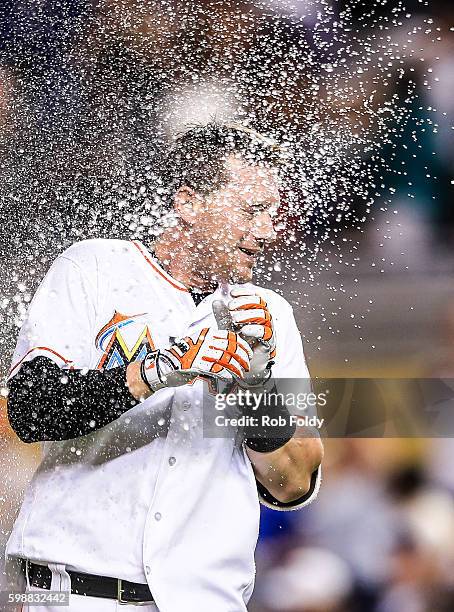 Chris Johnson of the Miami Marlins has water thrown in his face after hitting a walk-off double to end the game against the San Diego Padres at...