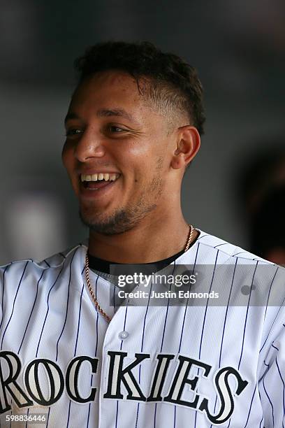 Cristhian Adames of the Colorado Rockies smiles in the dugout during a game against the Los Angeles Dodgers at Coors Field on August 31, 2016 in...