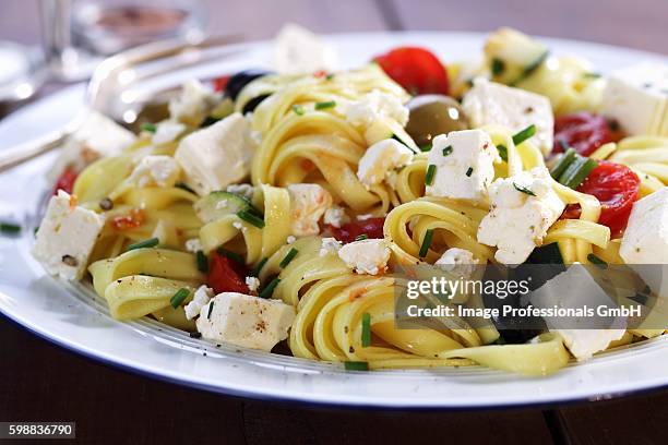 pasta with cherry tomatoes and feta - fetta stockfoto's en -beelden