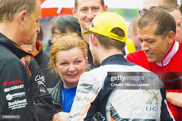 John McPhee of Great Britain and Peugeot Saxoprint MC celebrates his first victory with his mother under the podium at the end of the Moto3 race...