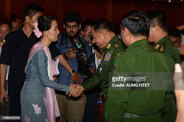 Myanmar's State Counsellor and Foreign Minister Aung San Suu Kyi greets military delegates at the conclusion of the peace conference in Naypyidaw on...