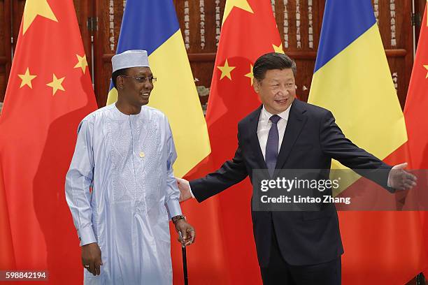 Chinese President Xi Jinping shake hands with Chad President Idriss Deby Itno before during their meeting at the West lake State Guest House on...