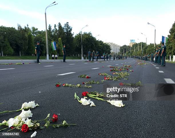 Flowers lie on a street after a hearse believed to be carrying the body of Uzbek President Islam Karimov passed through on the way to the airport in...