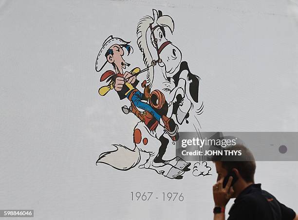 Man pass by a Lucky Luke comic strip table during the festival "Fete de la BD" in Brussels, on September 2, 2016. The comic strip festival "Fete de...