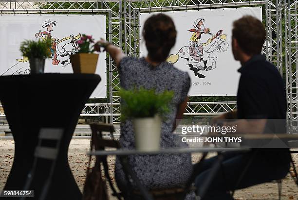 Quebec cartoonist Marc Delafontaine aka "Delaf" and screenwriter Maryse Dubuc, authors of the comic strip "Les nombrils", talk in front of Lucky Luke...