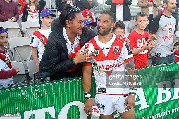 Benji Marshall of the Dragons poses for a photo with a fan after the round 26 NRL match between the St George Illawarra Dragons and the Newcastle...