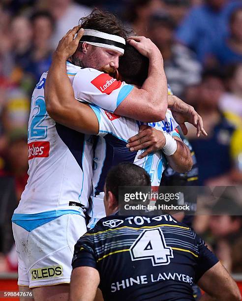 David Mead of the Titans celebrates with Chris McQueen of the Titans after scoring a try during the round 26 NRL match between the North Queensland...