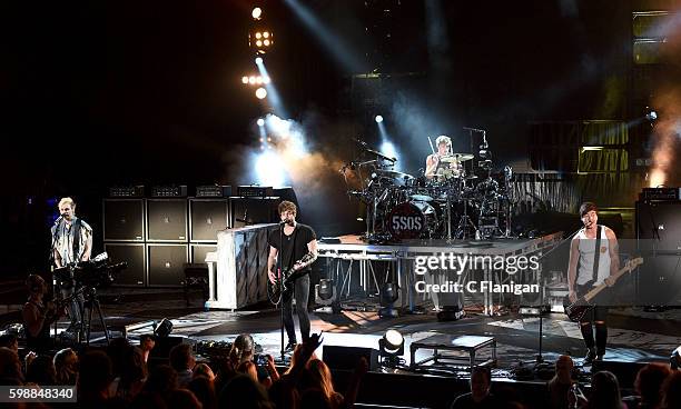 Musicians Michael Clifford, Luke Hemmings, Ashton Irwin and Calum Hood of 5 Seconds of Summer perform at Shoreline Amphitheatre on September 2, 2016...