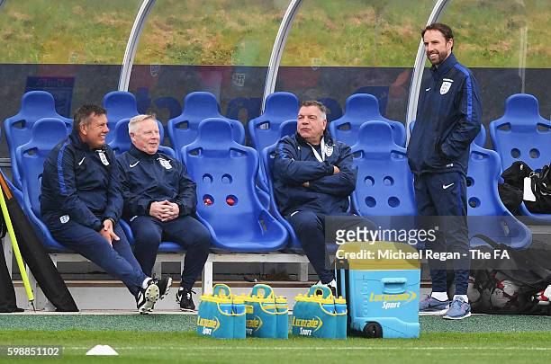 Sam Allardyce, manager of England talks with assistant manager Sammy Lee, Craig Shakespeare and Gareth Southgate during a training session at St....