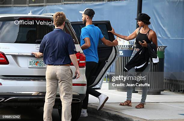 Benoit Paire of France and Shy'm leave the Stadium on day 3 of the 2016 US Open at USTA Billie Jean King National Tennis Center on August 31, 2016 in...