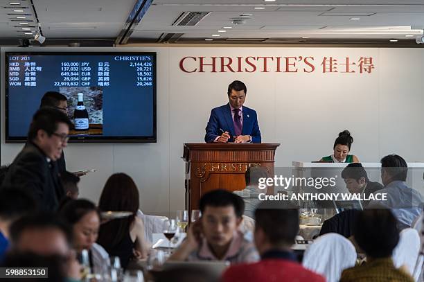 Christie's auctioneer registers the final bid for a 1865 Montrachet wine, which sold for 196,000 HKD, much more than the top range estimate of 60,000...