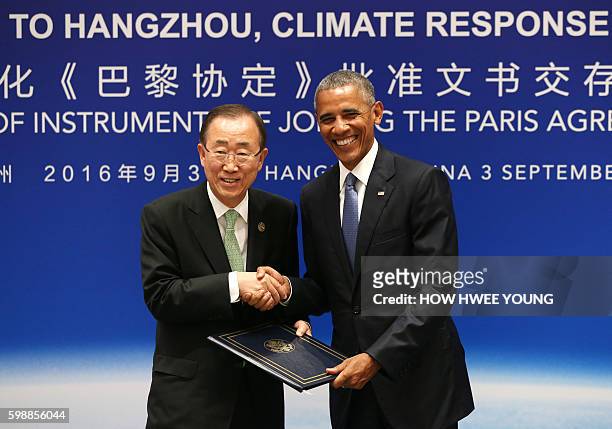 President Barack Obama shakes hands with UN Secretary General Ban Ki-moon during a joint ratification of the Paris climate change agreement with...