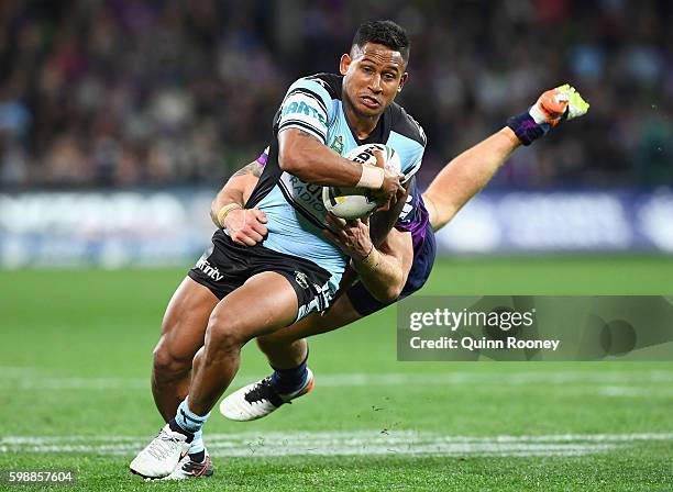 Ben Barba of the Sharks is tackled by Cheyse Blair of the Storm during the round 26 NRL match between the Melbourne Storm and the Cronulla Sharks at...