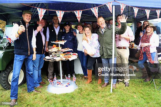 Zara Tindall and Adam Henson pictured with the winners of the Land Rover Tailgate picnic at Burghley Horse Trials during The Land Rover Burghley...