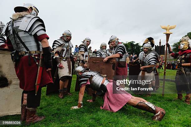 Roman soldier carries out press-ups in full armour ahead of a battle as the lives of Roman Legionnaires are re-enacted during the Hadrian's Wall Live...