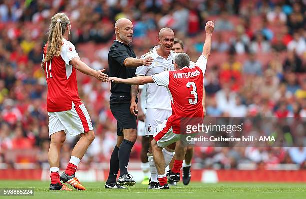 Referee Howard Webb looks on as Nigel Winterburn of Arsenal Legends goes down after Paolo Di Canio of Milan Glorie pretends to headbutt him during...