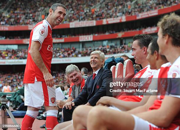 Arsenal substitute Martin Keown shares a joke with manager Arsene Wenger and assistant Pat Rice the friendly match between the Arsenal Legends and...