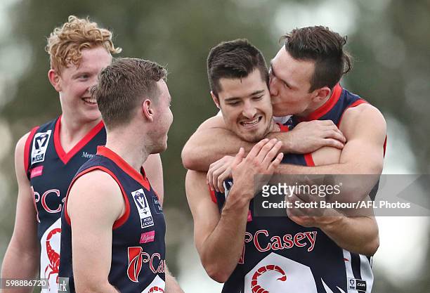 Liam Hulett of Casey Scorpions kisses his teammates after they won the VFL Qualifying Final match between Casey and Footscray at Casey Fields on...