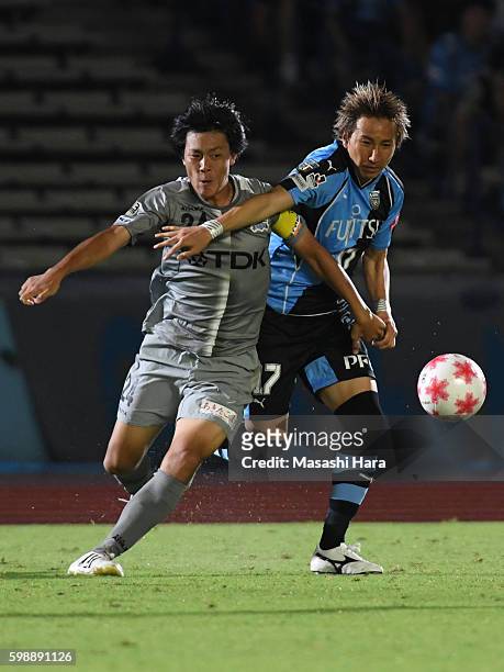 Yuto Takeoka of Kawasaki Frontale and Naoyuki Yamada of Blaublitz Akita compete for the ball during the 96th Emperor's Cup first round match between...