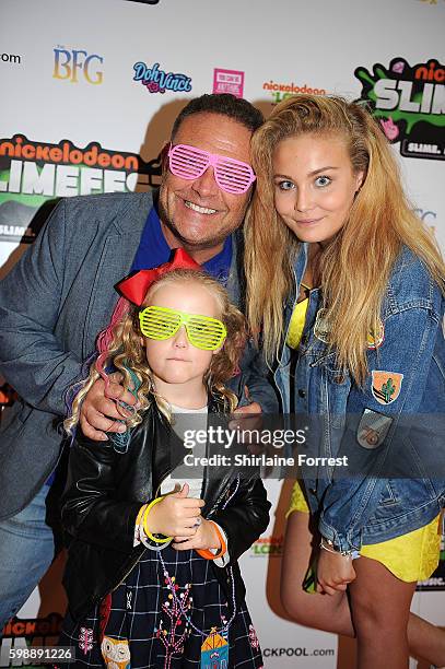 John Thomson poses with his daughters Olivia and Sophia during the first UK Nickelodeon SLIMEFEST at the Empress Ballroom on September 3, 2016 in...