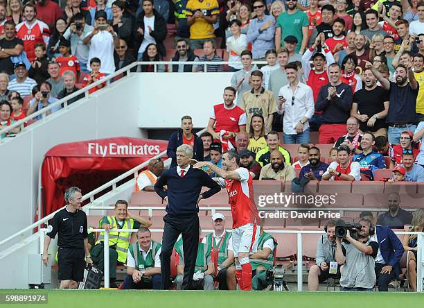 Martin Keown of Arsenal Legends pretends to strangle Arsenal Manager Arsene Wenger during the Arsenal Foundation Charity match between Arsenal...