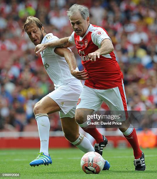 Anders Limpar of Arsenal Legends holds off Massimo Ambrosini of Milan during the Arsenal Foundation Charity match between Arsenal Legends and Milan...