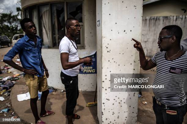 Man points out bullet holes at Gabon's opposition leader Jean Ping's headquarters on September 3, 2016 in Libreville. Post-election violence in Gabon...