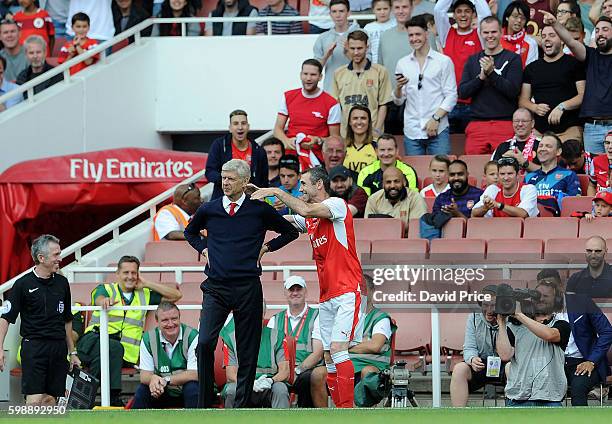 Martin Keown of Arsenal Legends pretends to strangle Arsenal Manager Arsene Wenger during the Arsenal Foundation Charity match between Arsenal...