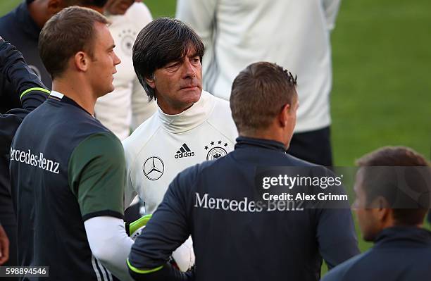 Head coach Joachim Loew stands next to newly announced team captain Manuel Neuer during a Germany press conference at Ullevaal Stadion on September...