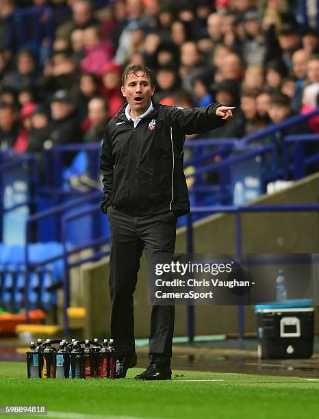 Bolton Wanderers manager Phil Parkinson shouts instructions to his team from the dug-out during the Sky Bet League One match between Bolton Wanderers...