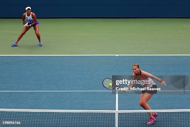 Michaella Krajicek of Netherlands and Heather Watson of the United Kingdom in action against Nao Hibino of Japan and Nicole Gibbs of the United...