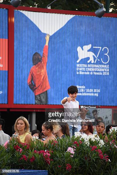 Fan watches celebrities on the red carpet of the premiere of 'The Young Pope' during the 73rd Venice Film Festival at on September 3, 2016 in Venice,...