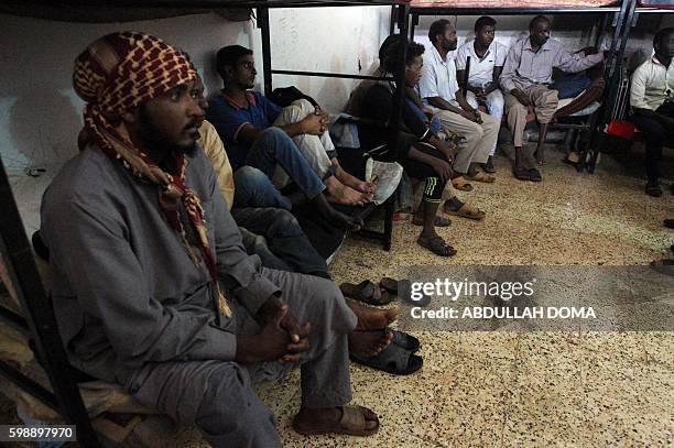 Illegal migrants from Chad, Sudan, Egypt and Bangladesh wait to receive aid distribution provided by the International Organization for Migration in...