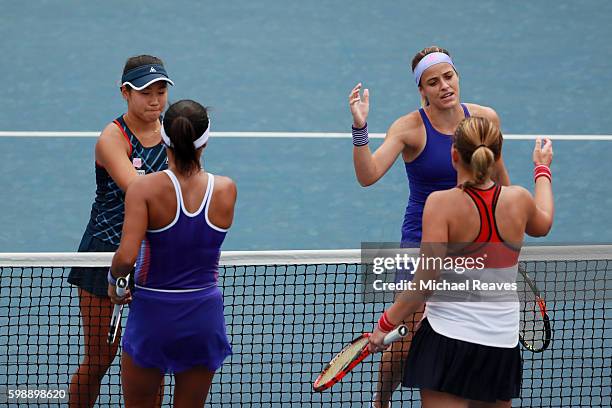 Nao Hibino of Japan and Nicole Gibbs of the United States shakes hands with Michaella Krajicek of Netherlands and Heather Watson of the United...