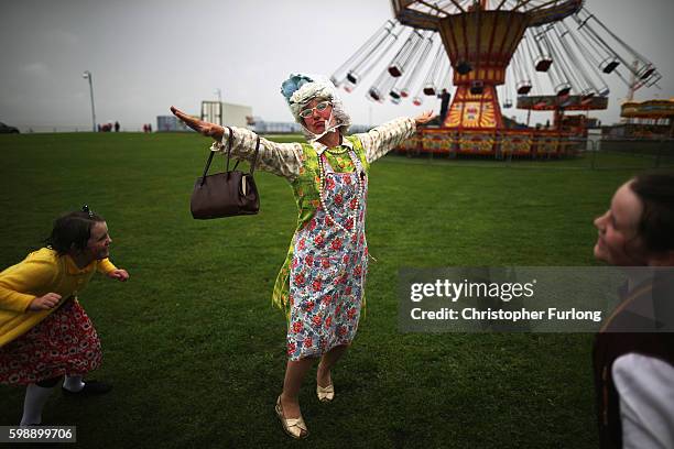 Performer Morag, of The Tea Ladies, does her own 'Flypast' after the scheduled flypast was cancelled due to the weather during the Vintage By The Sea...