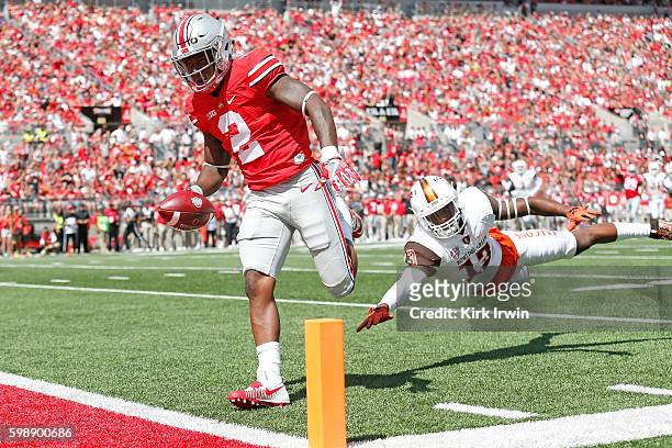 Dontre Wilson of the Ohio State Buckeyes out runs Jamari Bozeman of the Bowling Green Falcons to score a touchdown during the first quarter on...