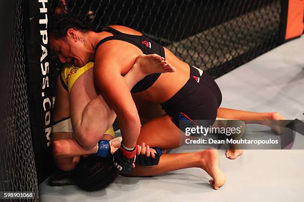 Ashlee Evans-Smith of the USA controls the body of Veronica Macedo of Venezuela in their Womens Bantamweight Bout during the UFC Fight Night held at...