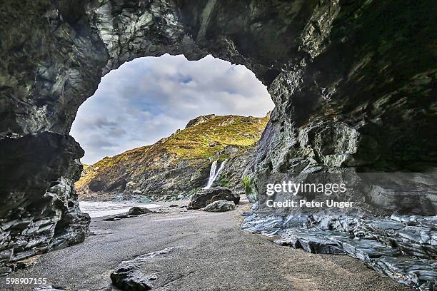 view out the entrance of merlin's cave, tintagel - cave stock pictures, royalty-free photos & images