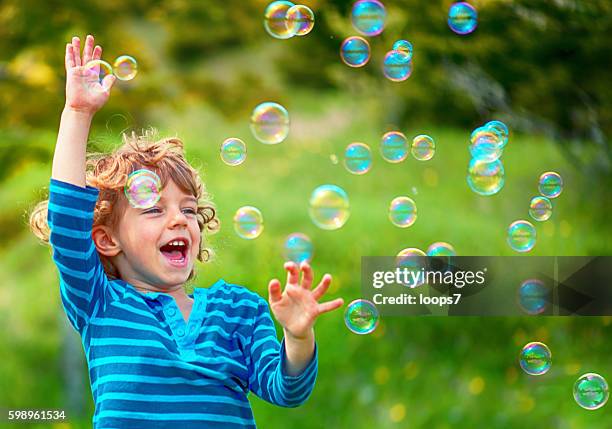 child and soap bubbles - soapbubble stock pictures, royalty-free photos & images