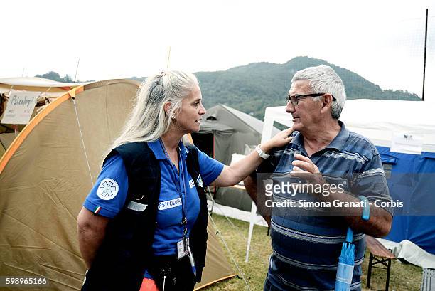 The Psychologist Dorotea Ricci talks with a man in the tent camp erected for earthquake victims on August 31, 2016 in Arquata del Tronto, Italy. The...